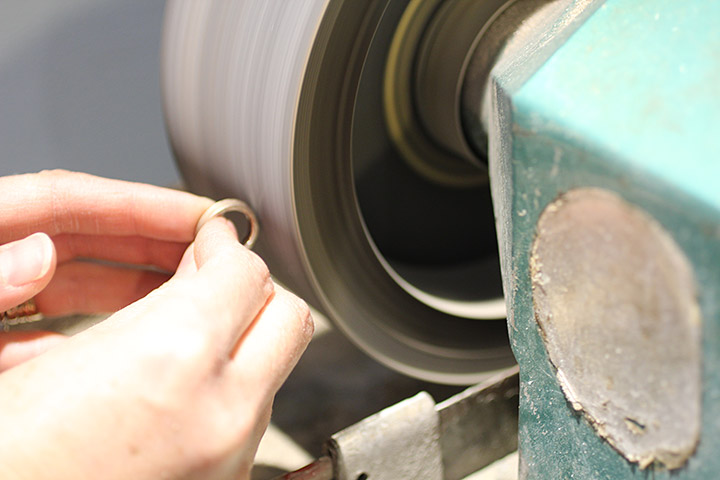 After the ring is hammered into shape, it is polished on our polishing wheel.